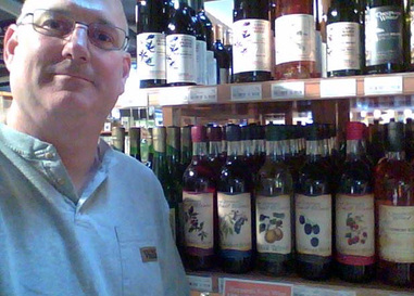 Jim Sheppard with wine selection produced by Sheppard Fruit Wines