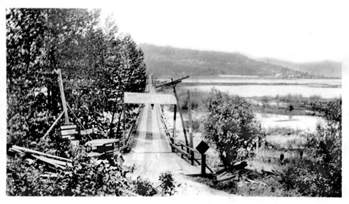 Old picture of original bridge across the coeur d'Alene River at Harrison, Id